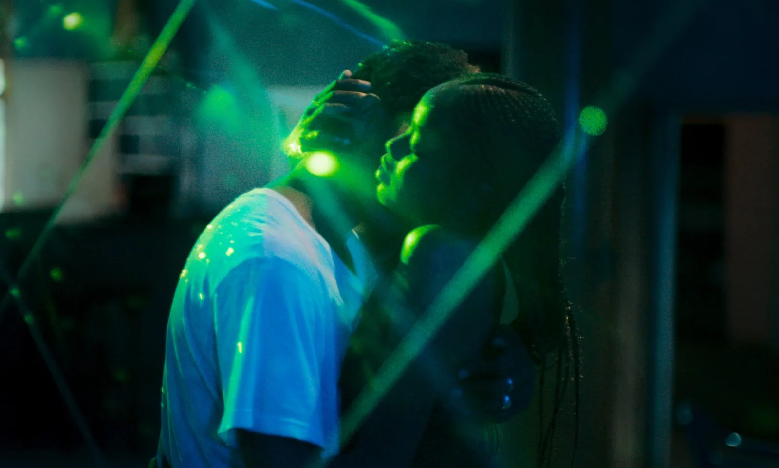 Two people dancing in a dark neon-lit club in Mati Diop’s Atlantics