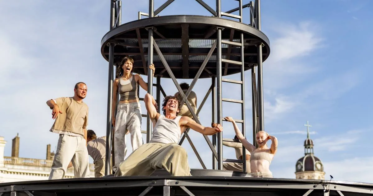 Dancers in 360 performing around a circular metal stage structure