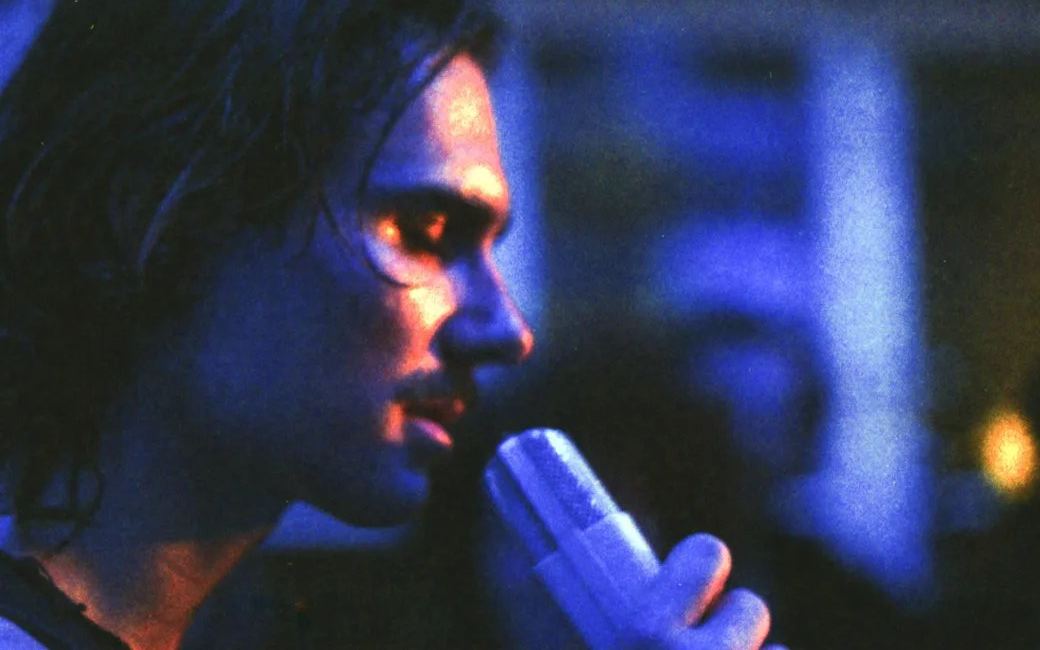 John Moods performing under blue light